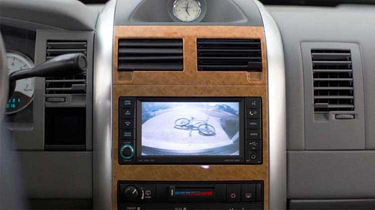 Driver using review safety by utilizing their backup camera.