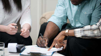 A man signs a lease agreement.